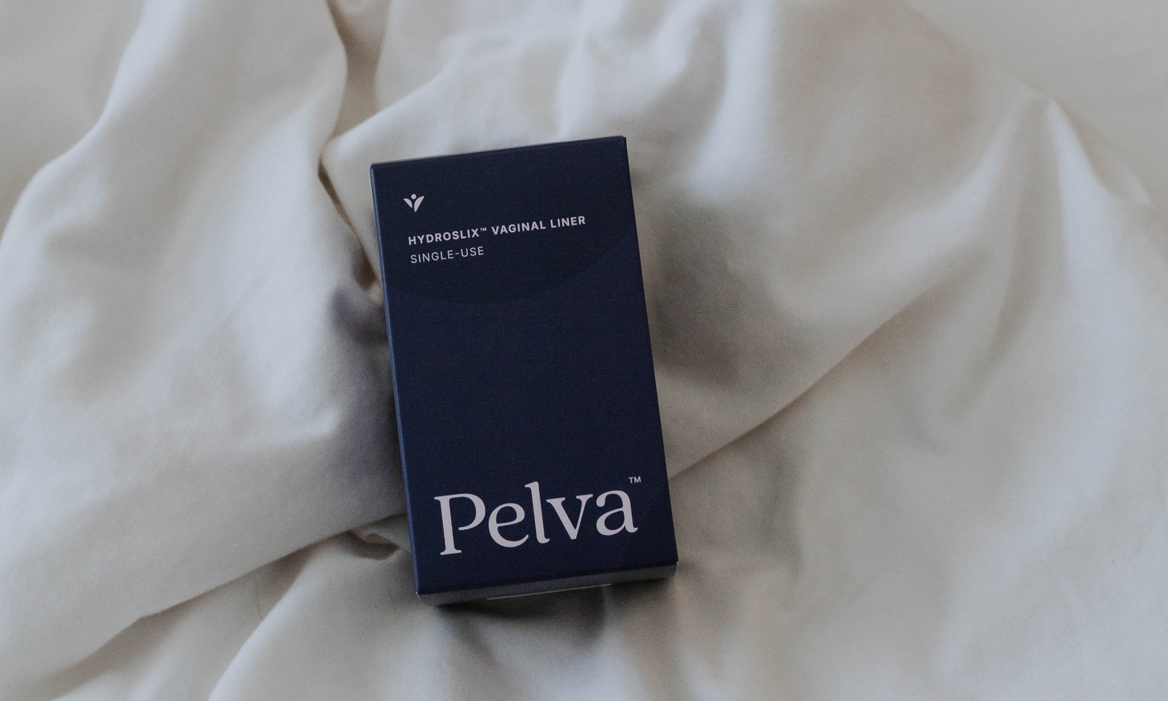 Dark blue product box on a white comforter